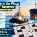 Tugboat moving a large ship through water in a harbor